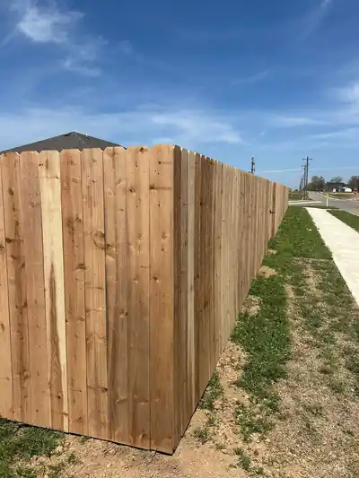 Cedar privacy fence running beside a public sidewalk