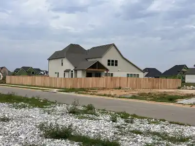Long cedar privacy fence run along a street in a new subdivision